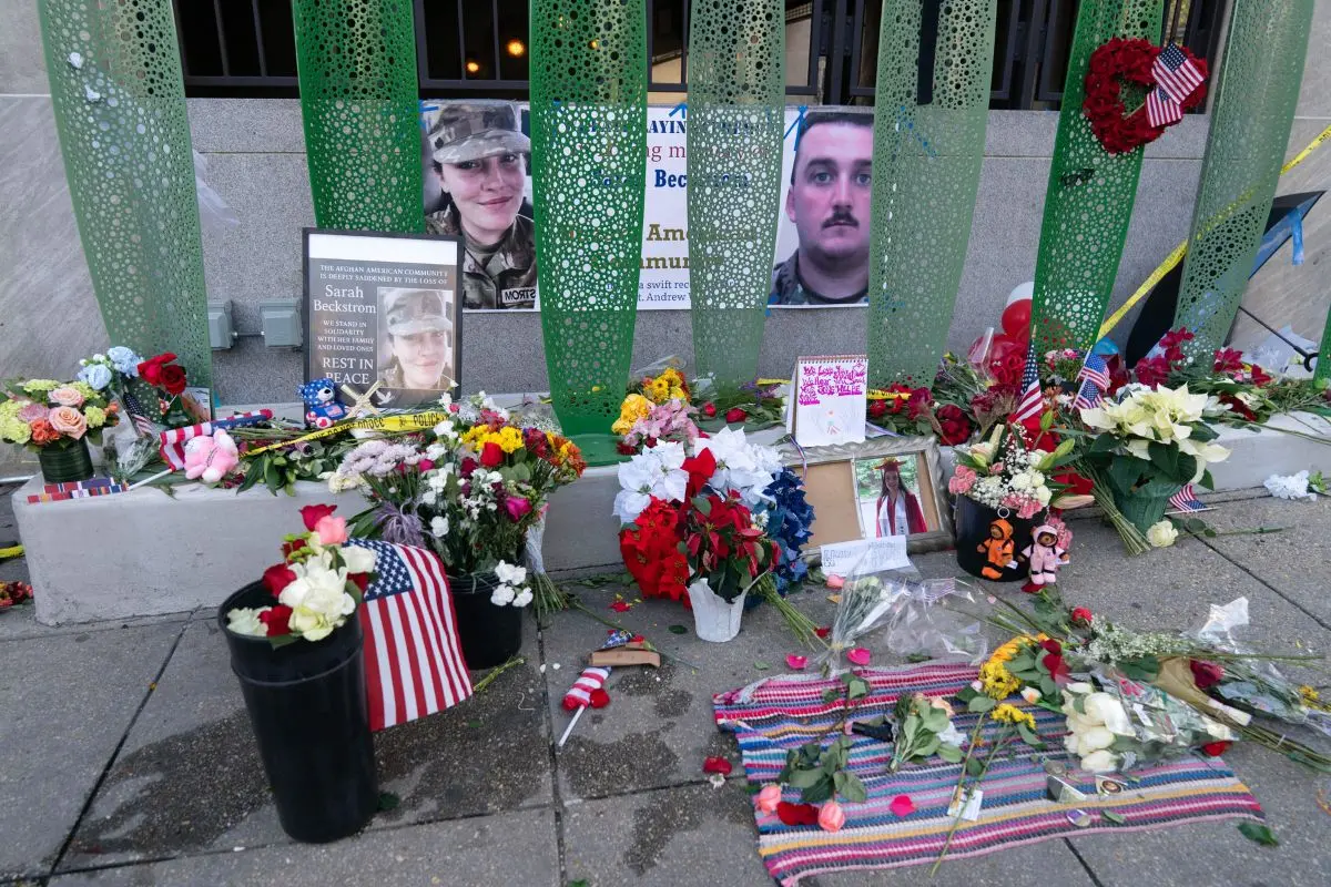 A makeshift memorial of flags, flowers and other items outside of Farragut West Station, near the site where two National Guard members were shot | Photo: AP
