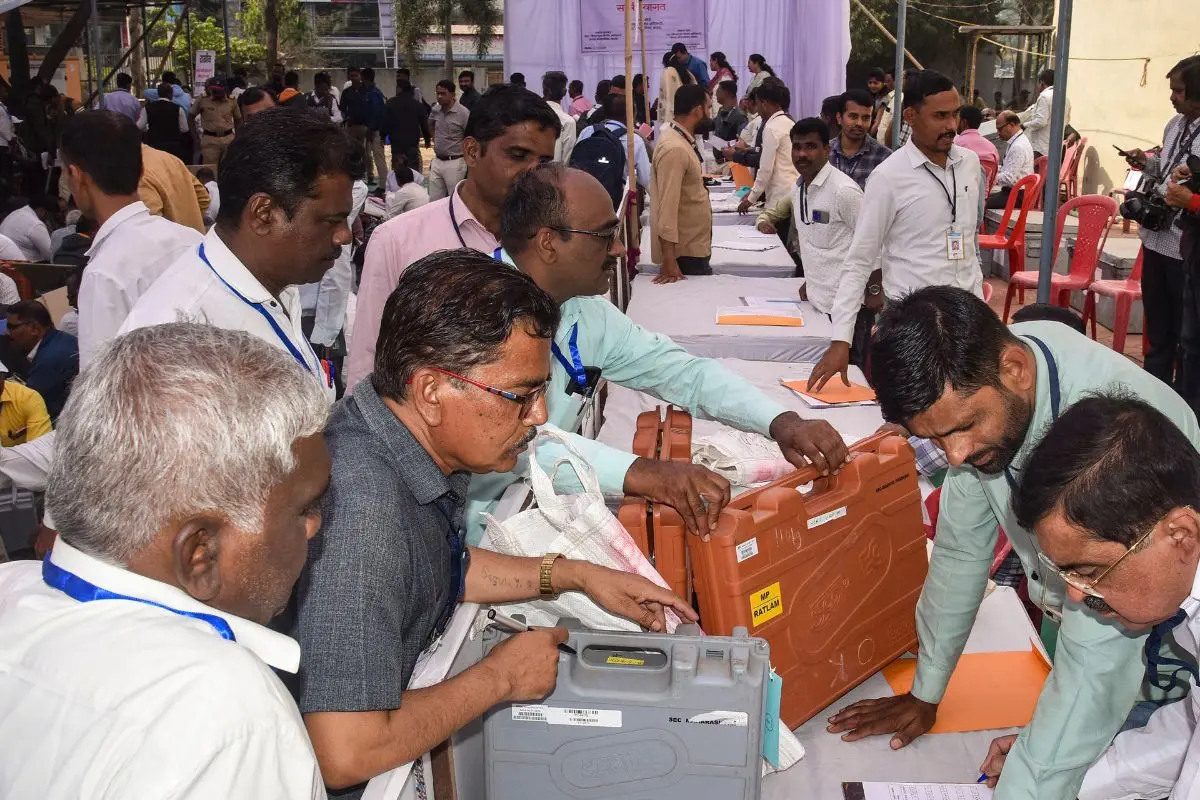 Polling officials at an election material distribution centre before leaving for their respective polling booths, a day before the Maharashtra local body elections. Photo: PTI