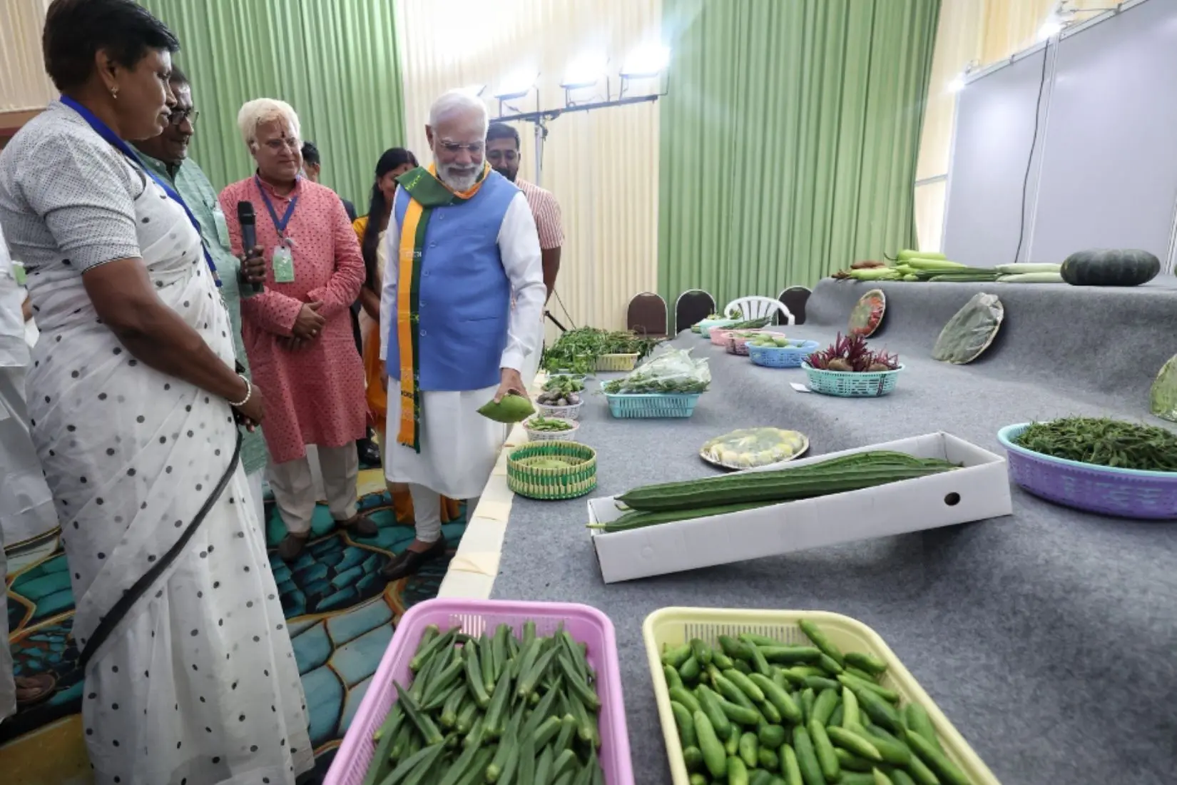 PM Modi observing the array of fresh vegetables showcased by Tamil Nadu farmers during the South India Natural Farming Summit 2025 in Coimbatore