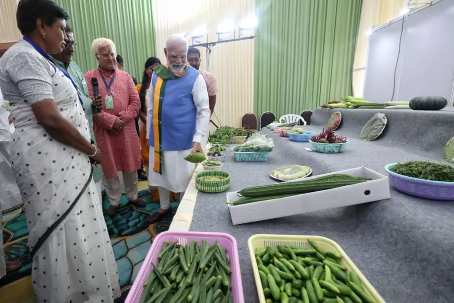 PM Modi observing the array of fresh vegetables showcased by Tamil Nadu farmers during the South India Natural Farming Summit 2025 in Coimbatore