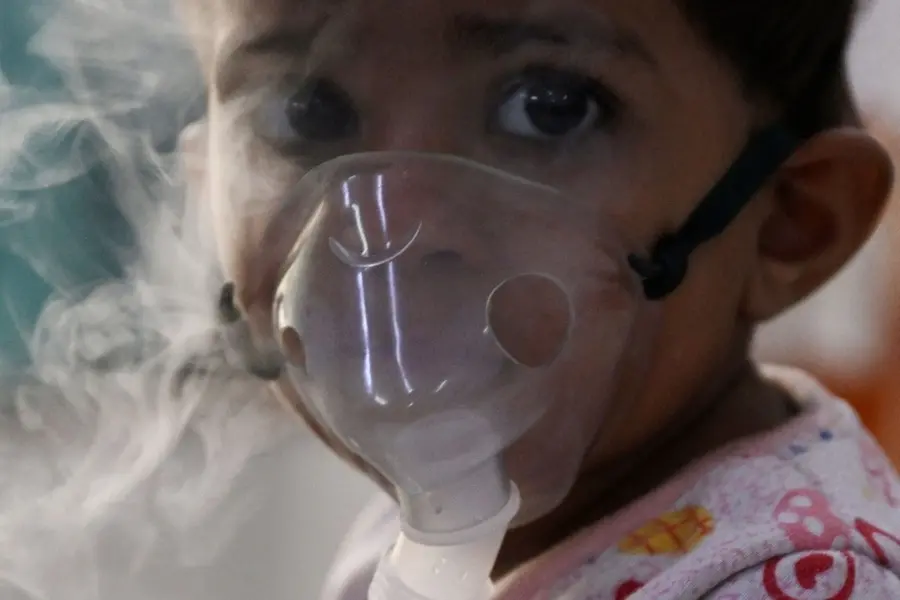 File photo: a child with breathing difficulties breathes with the help of a nebuliser
