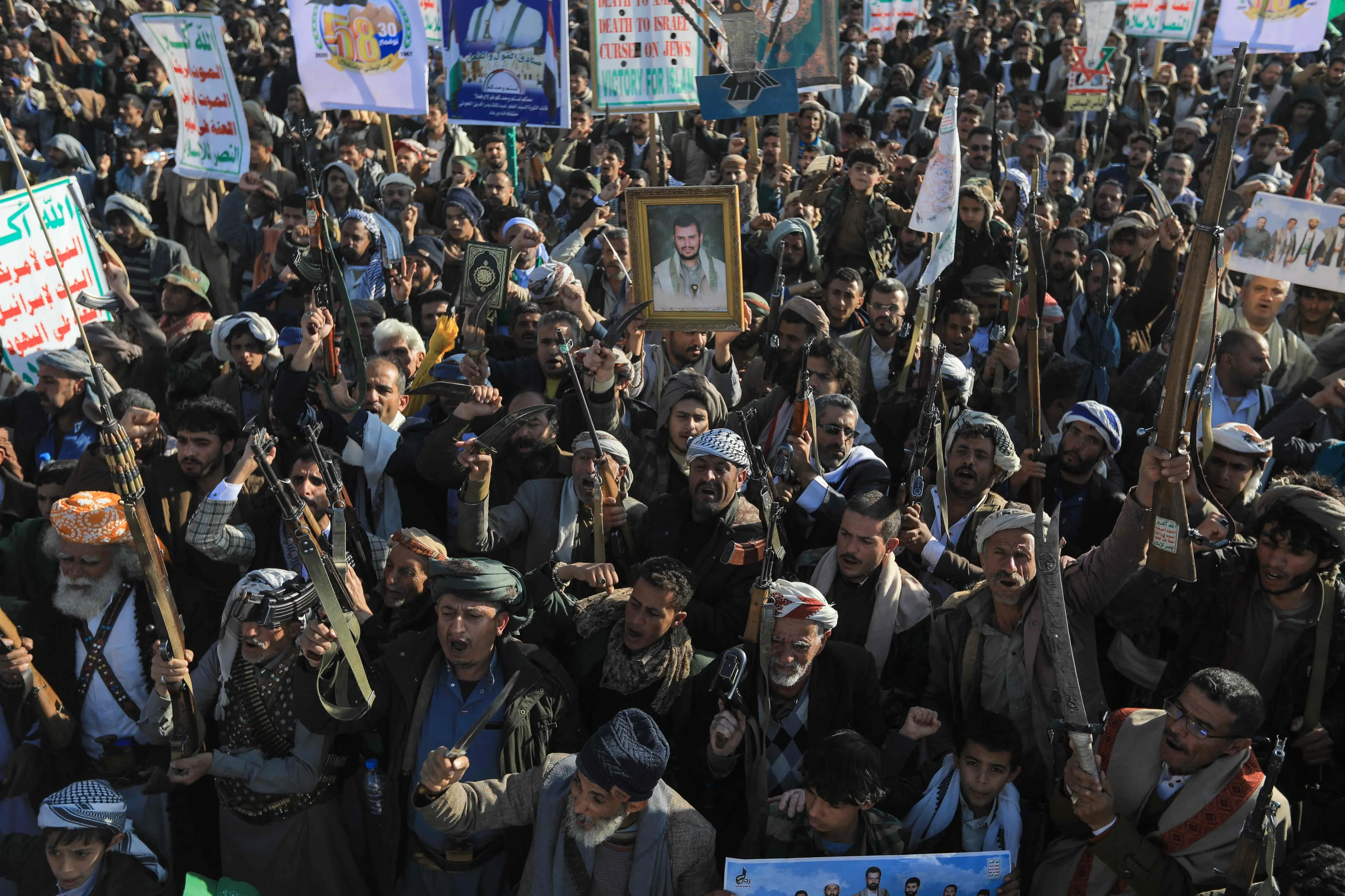 Houthi supporters in Yemen brandish weapons during a demonstration marking Independence Day, the anniversary of the end of British rule in southern Yemen in 1967, in the Houthi-controlled Yemeni capital Sanaa on November 30 | Photo: AFP