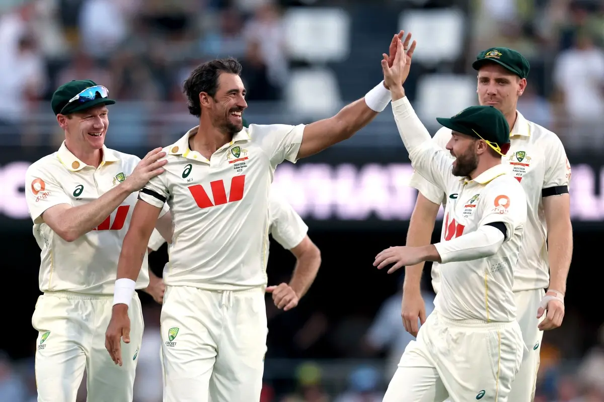 Australia's Mitchell Starc (C) celebrates with teammates after claiming an English wicket. | Photo: AFP