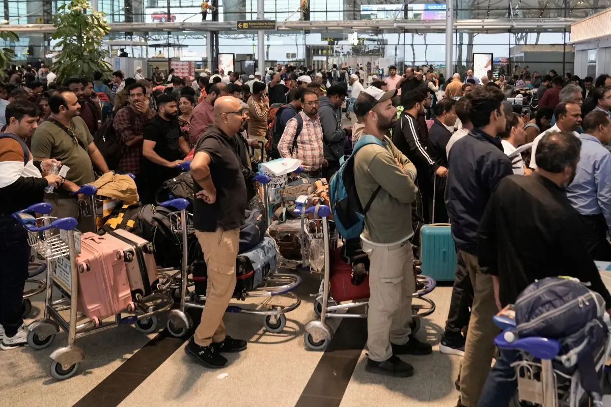 Passengers line up at an IndiGo Airlines ticket counter at the Rajiv Gandhi International Airport in Hyderabad, India, as several Indigo Airlines flights were either cancelled or delayed. (AP Photo/Mahesh Kumar A)