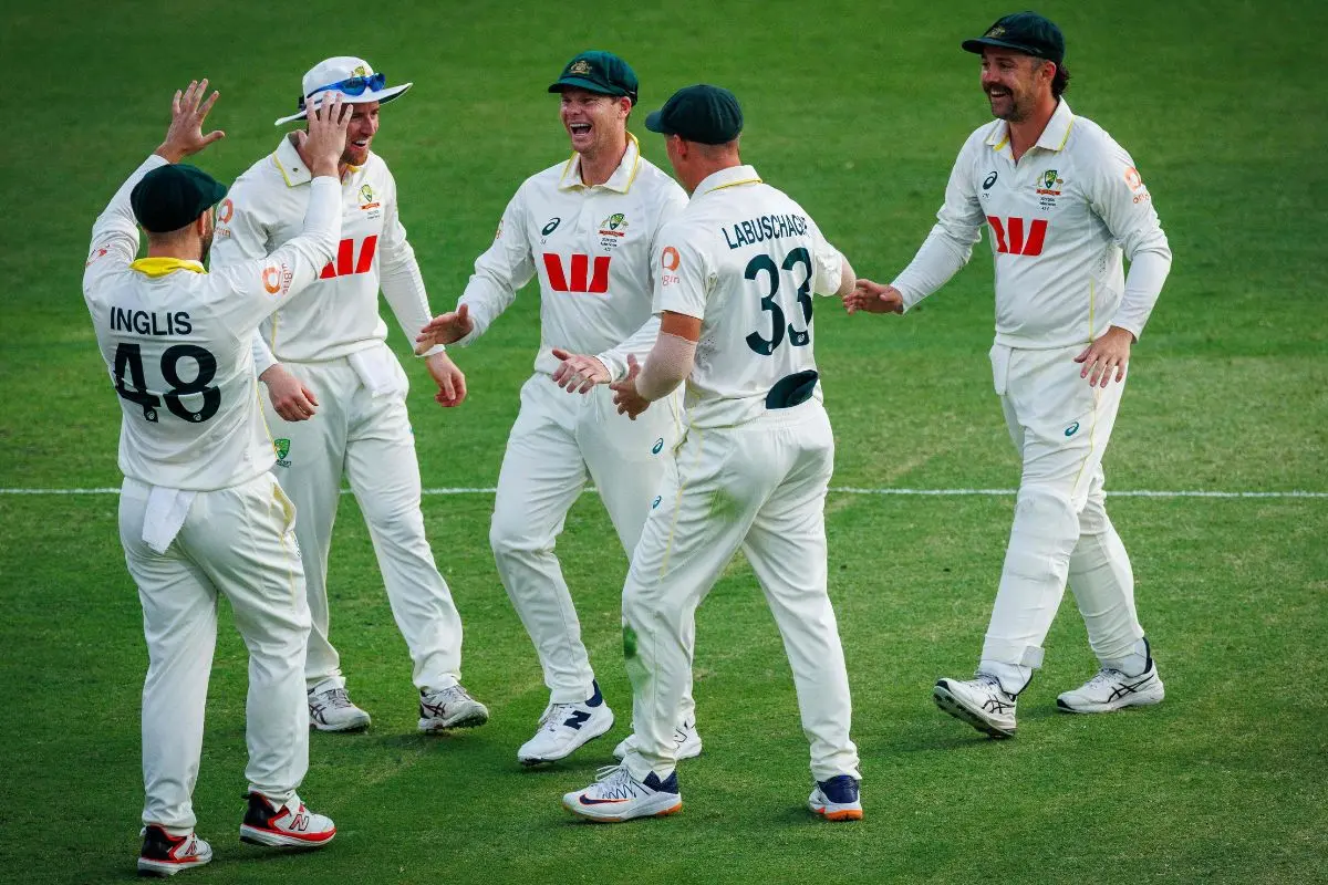 Australia players celebrate the wicket of England's Will Jacks on day four of the second Ashes cricket Test match between Australia and England at The Gabba in Brisbane on December 7, 2025. (Photo by Patrick HAMILTON / AFP)