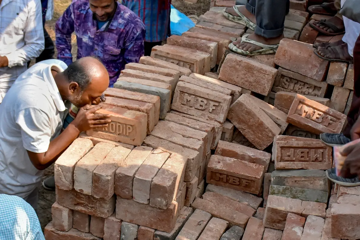 File Photo: People stand near stacks of bricks in view of former TMC MLA Humayun Kabir's plan to lay the foundation stone for a mosque, modelled on Ayodhya's Babri Masjid | PTI