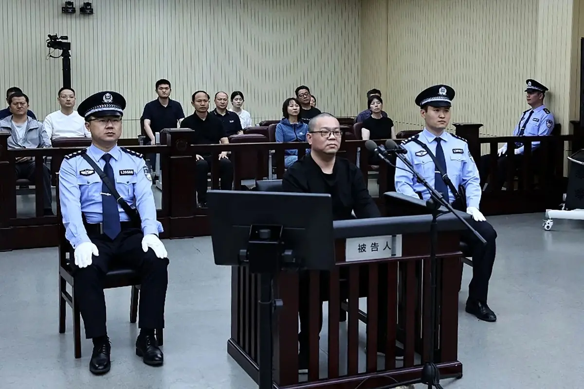 This photo released by the Tianjin No.2 Intermediate People's Court on May 28, 2024 shows Bai Tianhui (C), the former general manager of China Huarong International Holdings (CHIH) during his sentencing at the court on May 28, 2024 | Photo: AFP