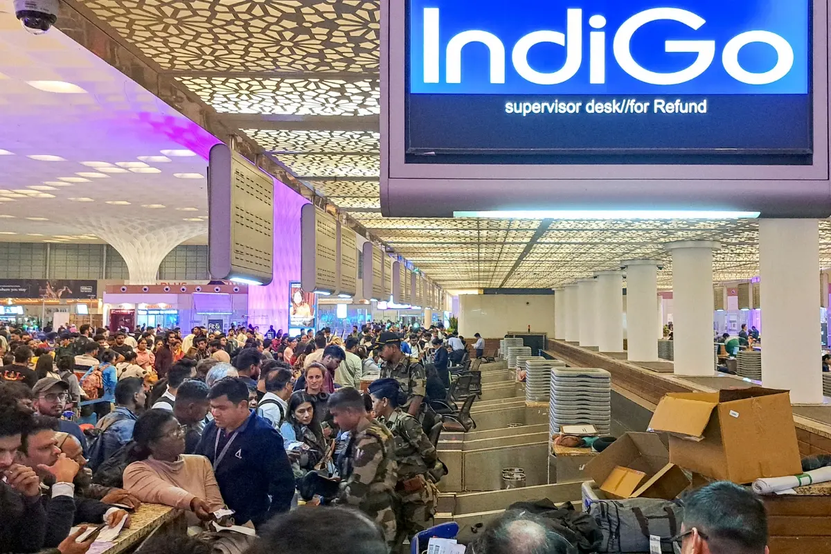 Stranded passengers stand in a queue at a counter after IndiGo cancelled more than 400 flights | Photo: PTI