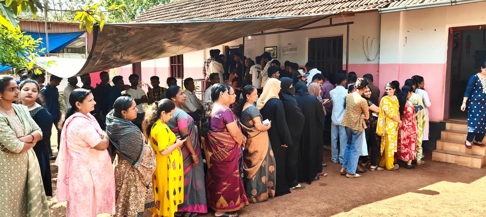 People standing in queue to vote at Koothuparampa Mooryad Kunjammu Memorial School | Photo: C Sunil Kumar/ Mathrubhumi