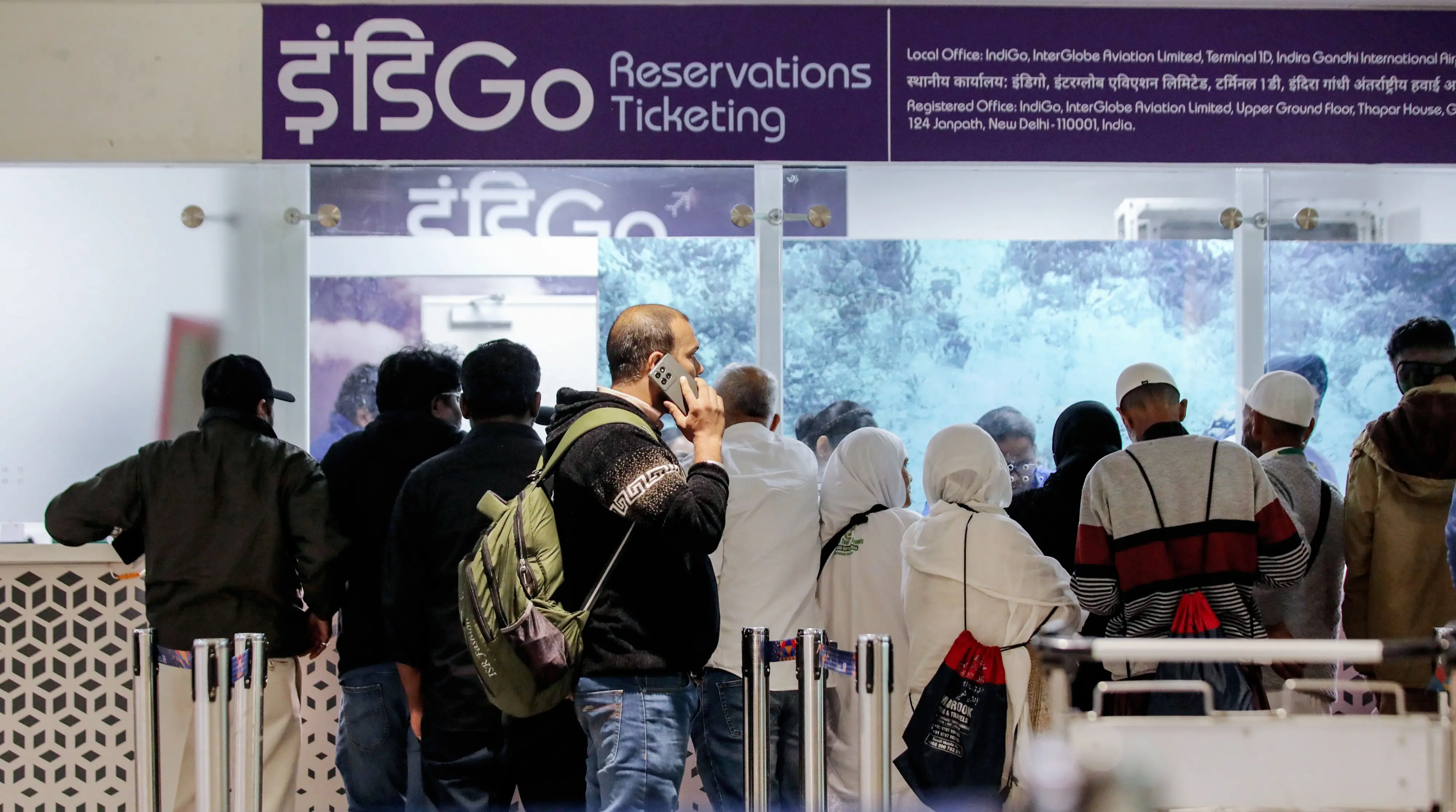 Stranded passengers stand at the IndiGo airline ticket counter after IndiGo cancelled flights at Indira Gandhi International Airport, in New Delhi | Photo: ANI