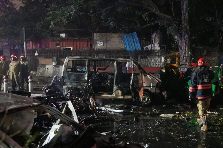 Firefighters at the spot after a blast occurred in a parked car near Red Fort, leaving multiple vehicles in flames