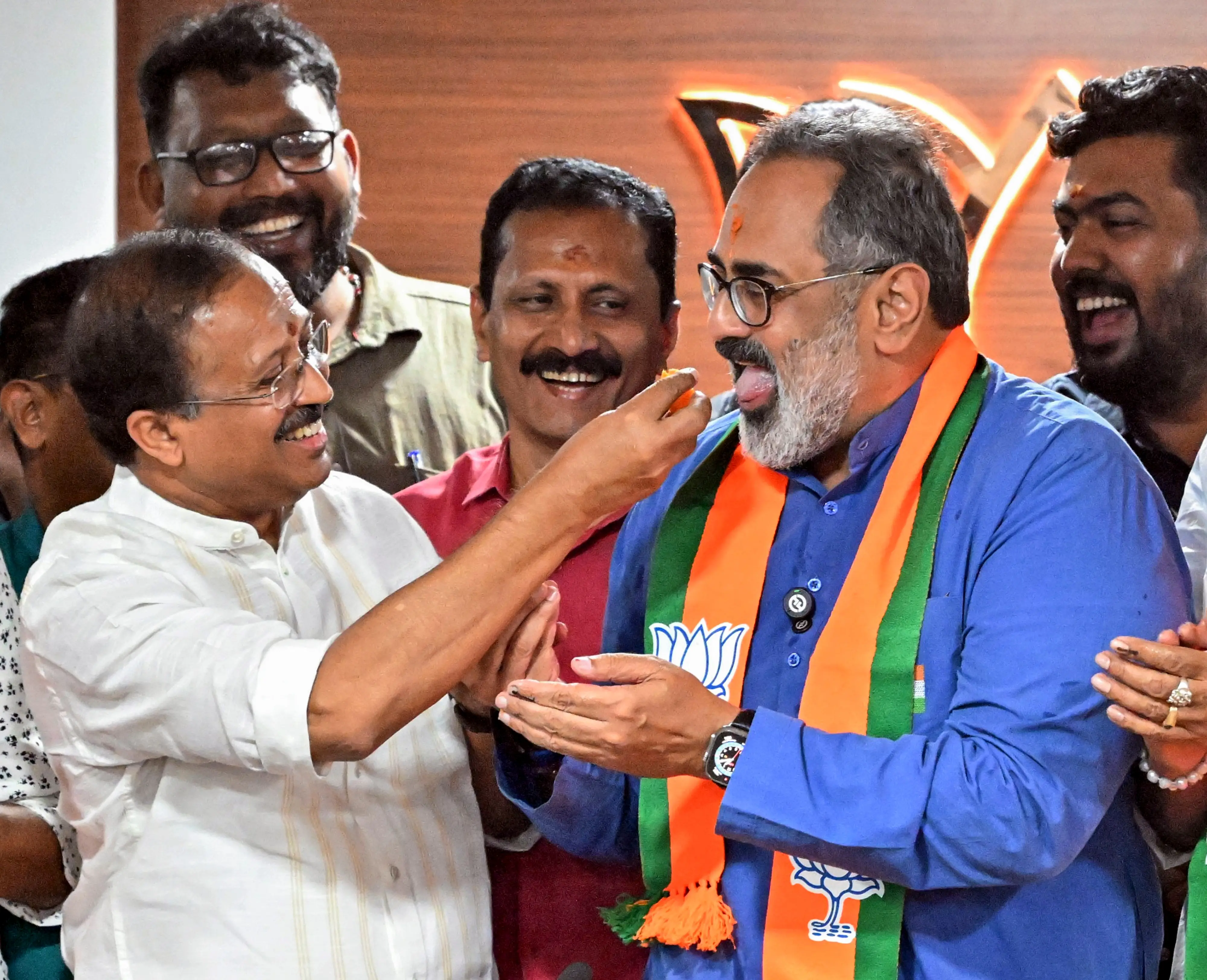 Kerala BJP President Rajeev Chandrasekhar, front right, being offered sweets by senior party leader V Muraleedharan, left, during the celebration of the party-led NDA's victory from Thiruvananthapuram Corporation in Kerala's local body elections | Photo: PTI