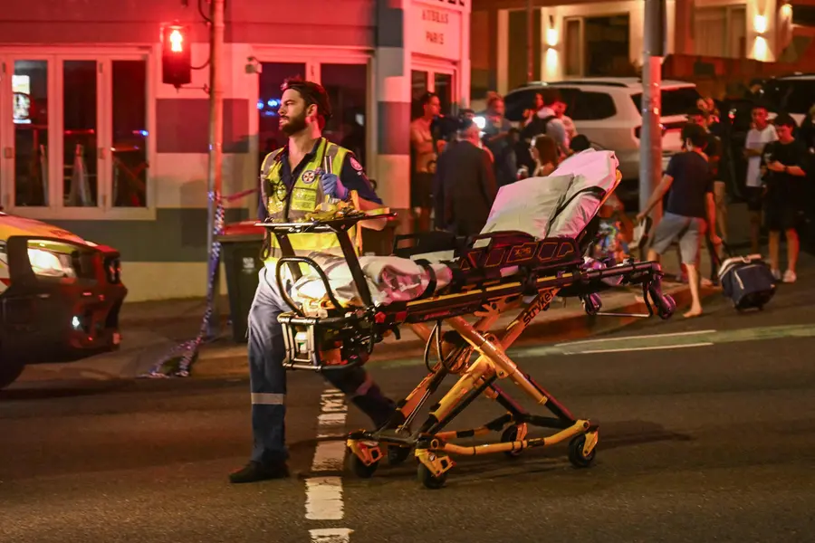 A health worker moves a stretcher after a shooting incident at Bondi Beach in Sydney