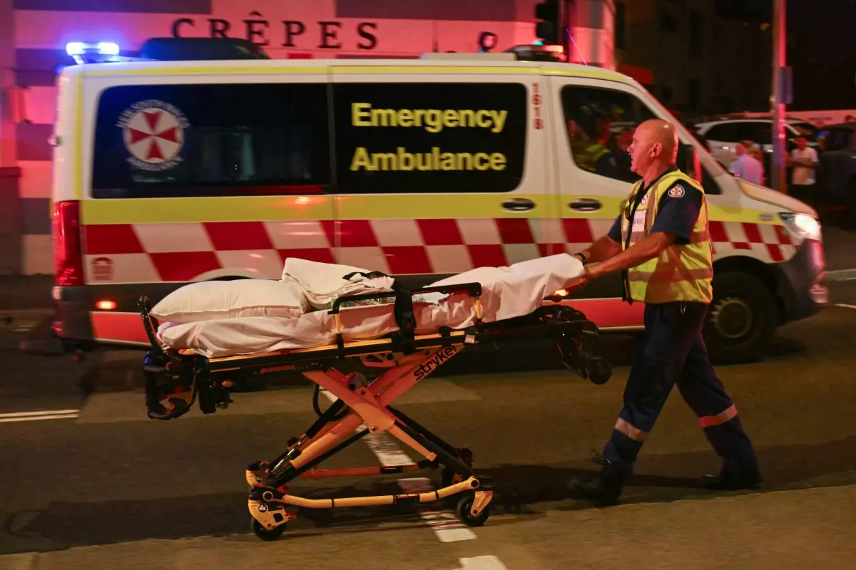 A health worker moves a stretcher after a shooting incident at Bondi Beach in Sydney | Photo: AFP