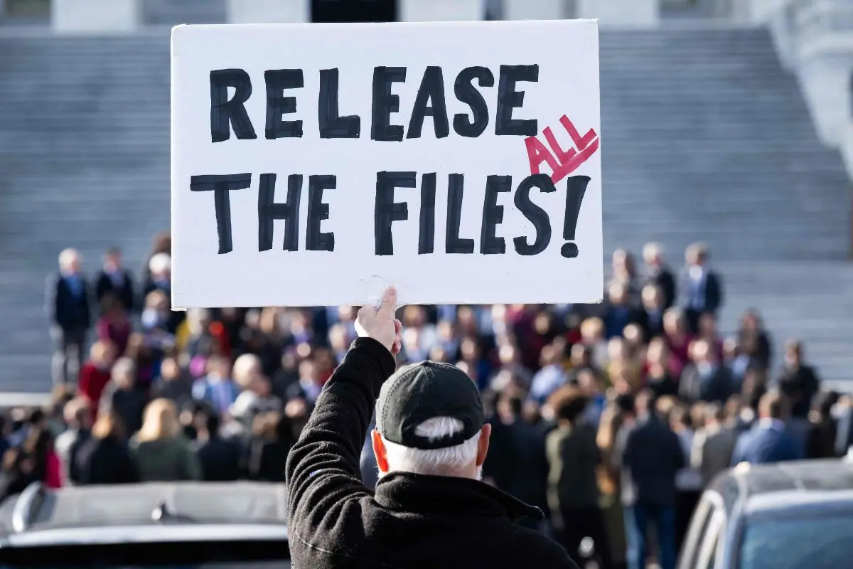 A protester holds a sign related to the release of the Jeffrey Epstein case files outside the US Capitol | Photo: AFP