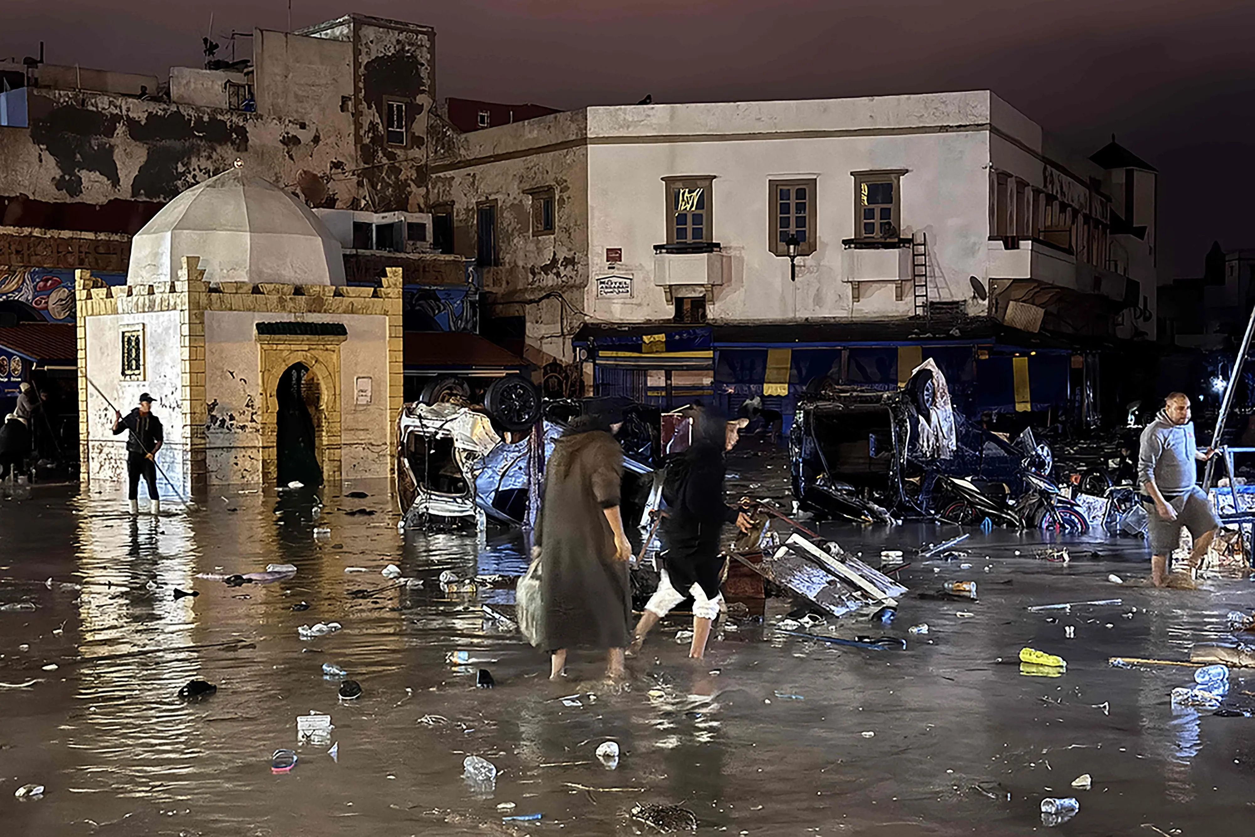 People wade through a square after a flash flood in Safi | Photo: AFP