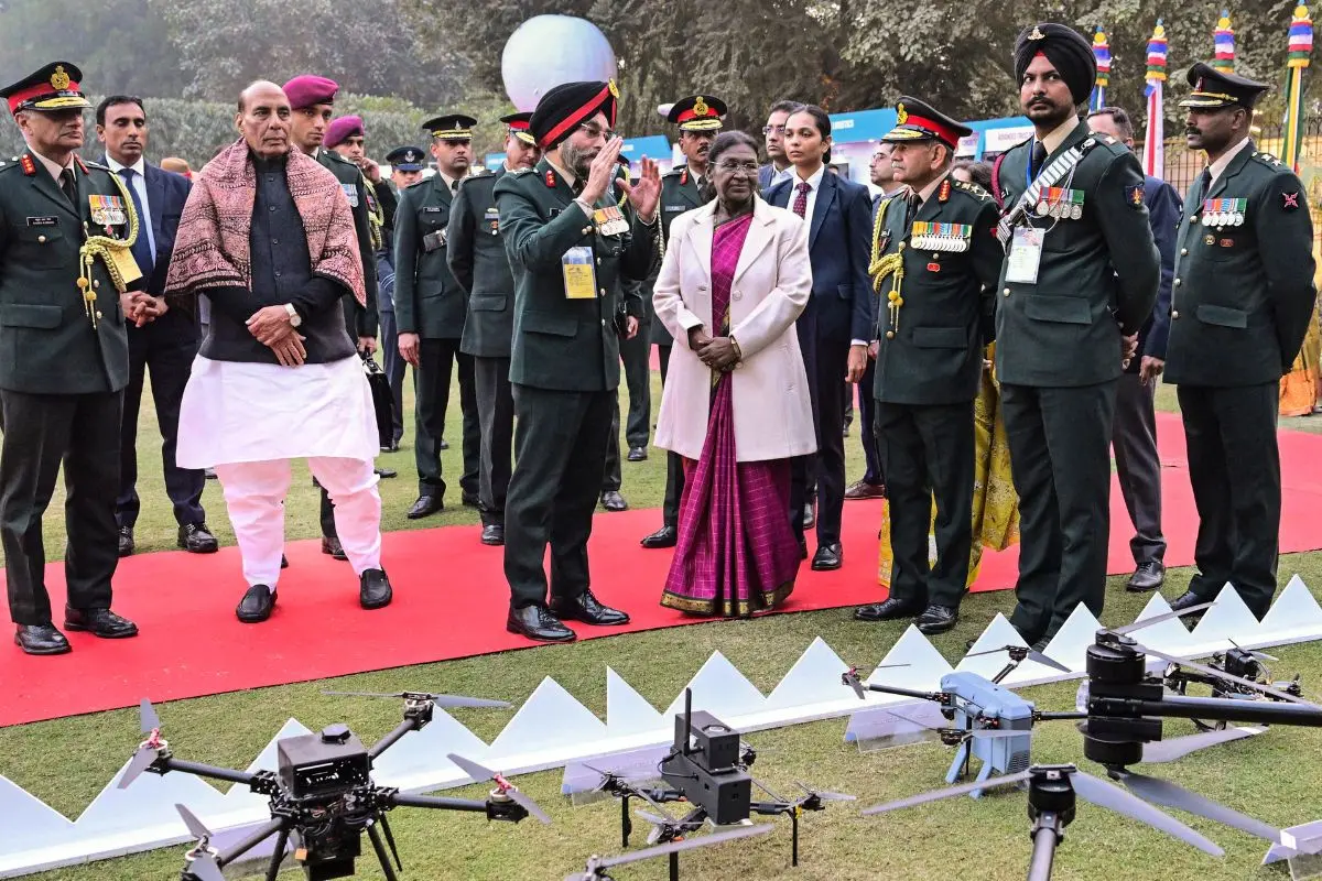 President Droupadi Murmu with Defence Minister Rajnath Singh and Chief of the Army Staff General Upendra Dwivedi and others during an 'At-Home' reception on the eve of 'Vijay Diwas', at Army House, in New Delhi. (@rashtrapatibhvn/X via PTI Photo)