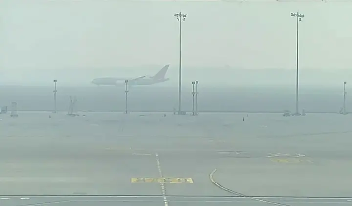An aircraft lands at the runway as dense smog reduce visibility and engulfs IGI airport in New Delhi | File photo: ANI