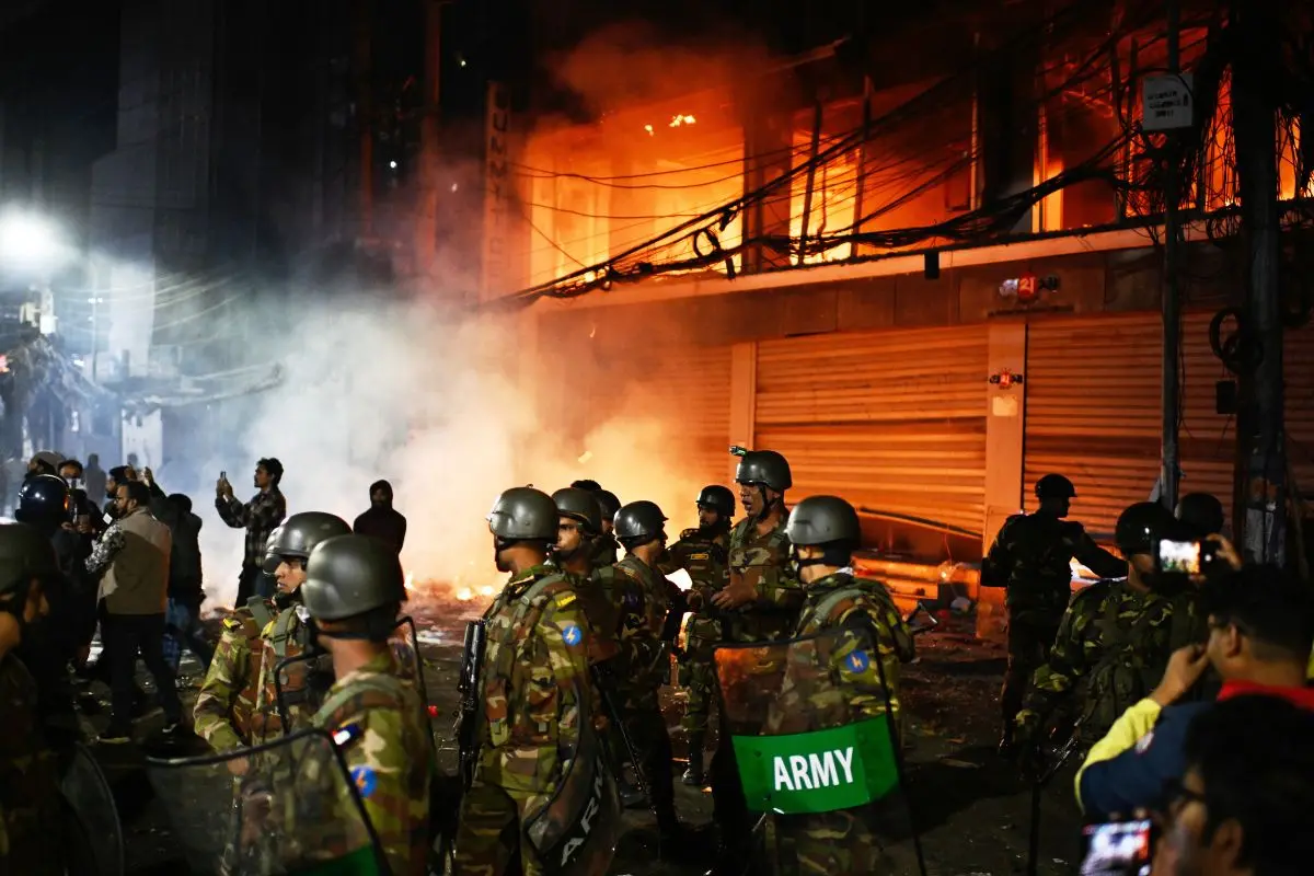 Bangladesh army stands guard at the premises of the Prothom Alo daily newspaper after angry protesters set it on fire after news reached the country from Singapore of the death of a prominent activist Sharif Osman Hadi. | Photo: AP
