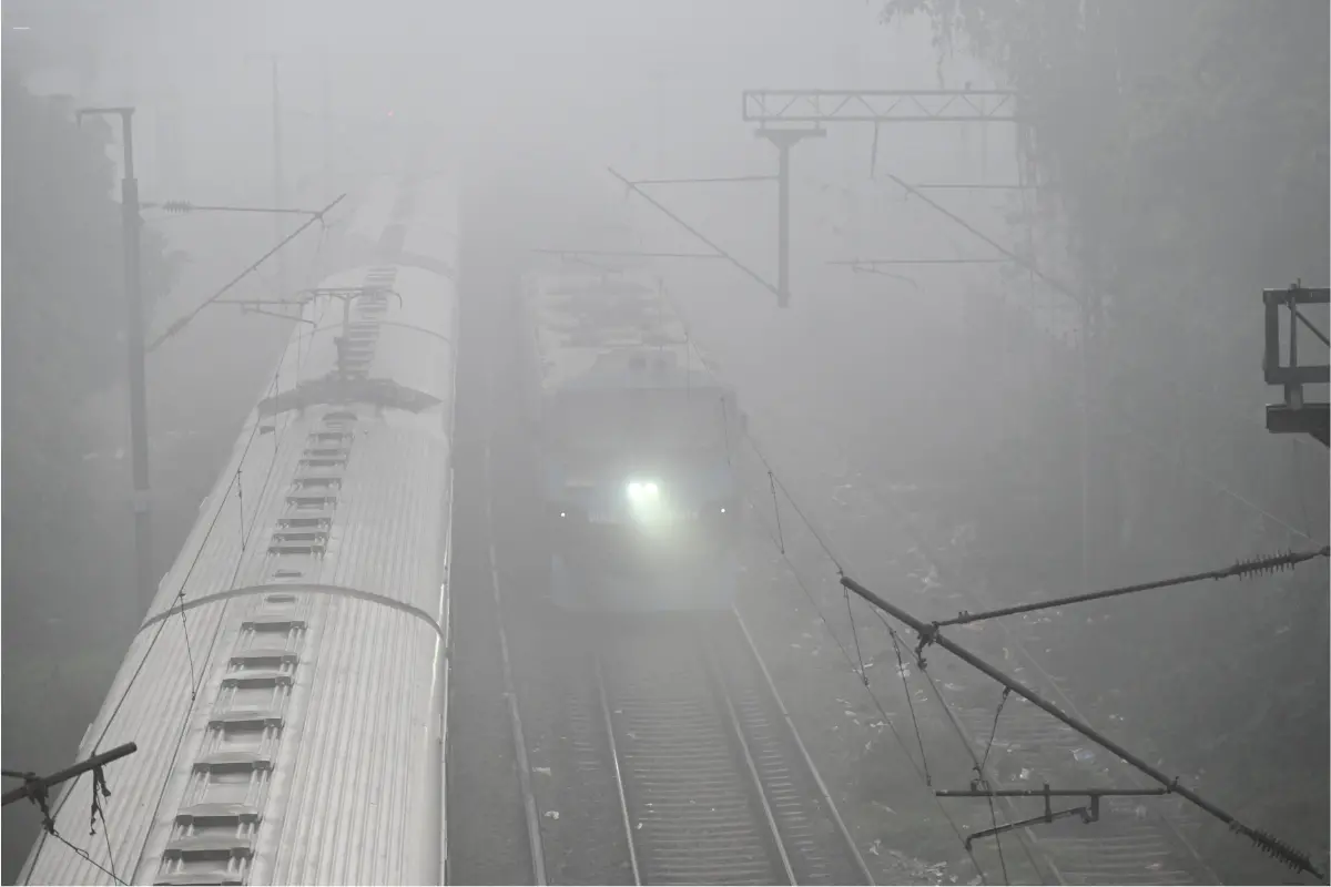 Passenger trains pass through dense fog on a cold winter morning, in Patna | photo: ANI