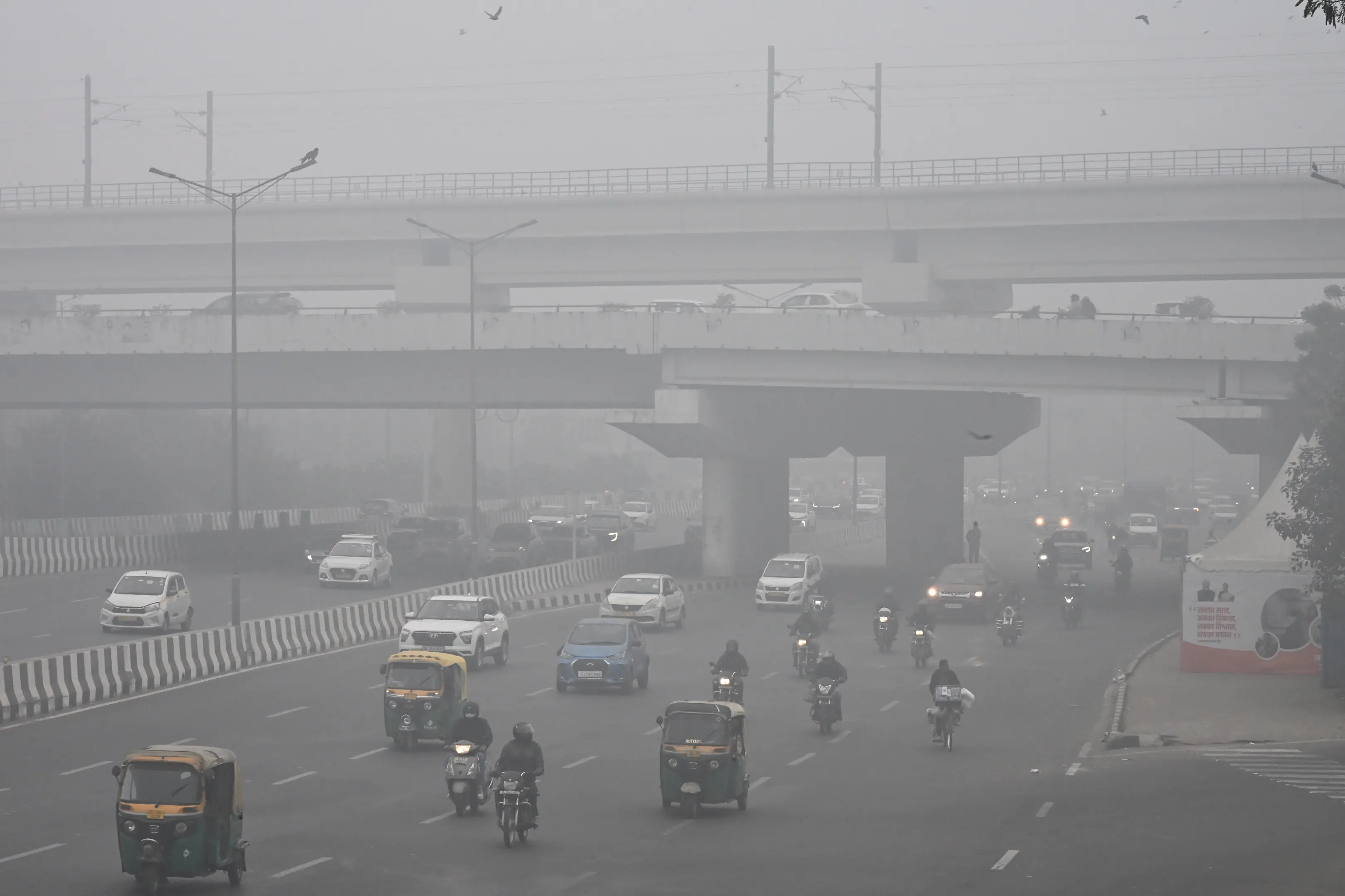 Vehicles commute amid dense smog on a cold winter morning in New Delhi, Saturday. | Photo: ANI