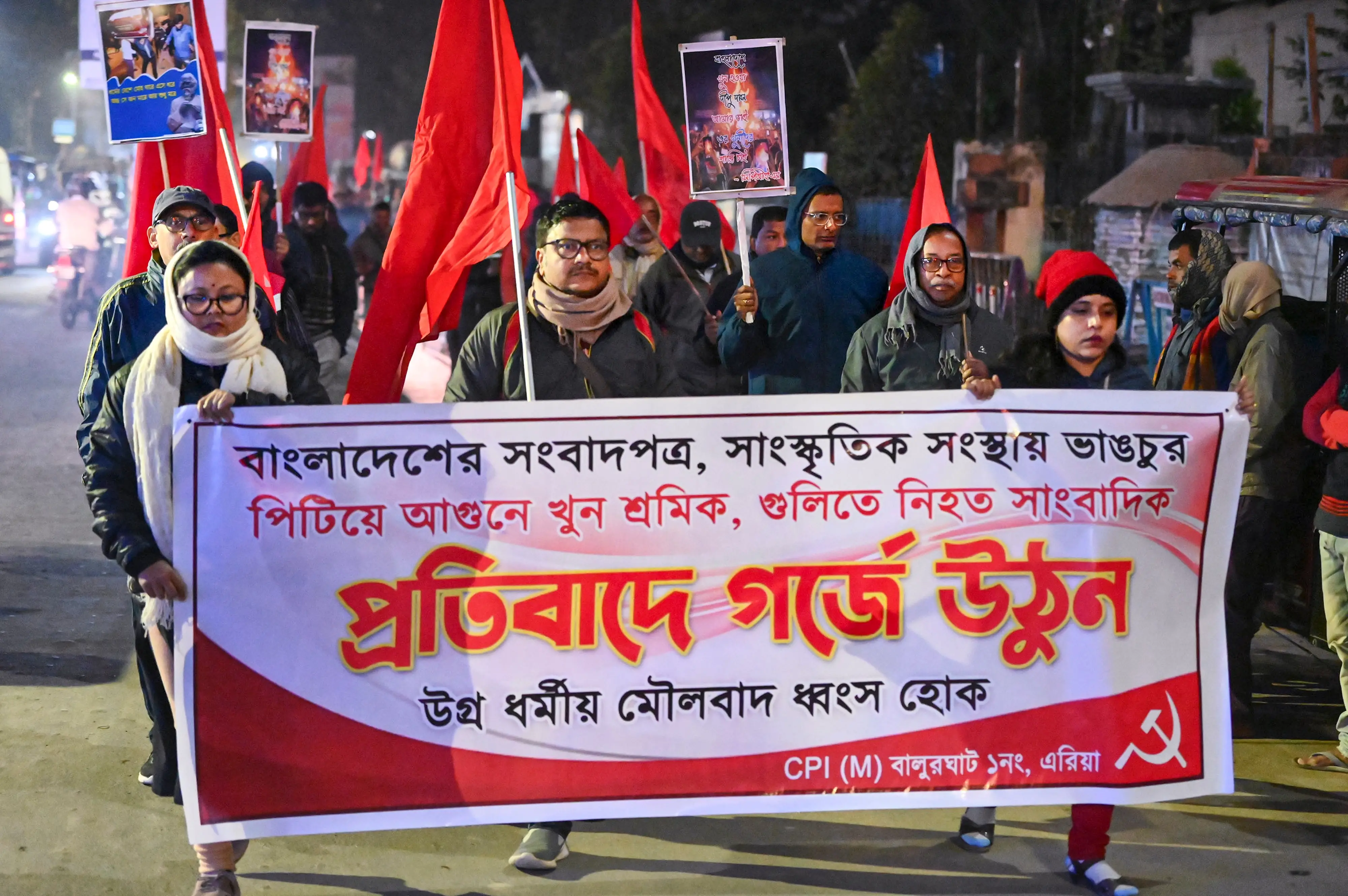CPI (M) workers take out a protest march over alleged attacks on media houses, journalists, cultural centres etc. in Bangladesh, in Dakshin Dinajpur district, West Bengal.| Photo: PTI