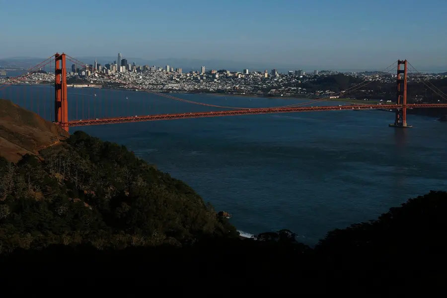 An aerial view of the Golden Gate Bridge in front of the San Francisco skyline