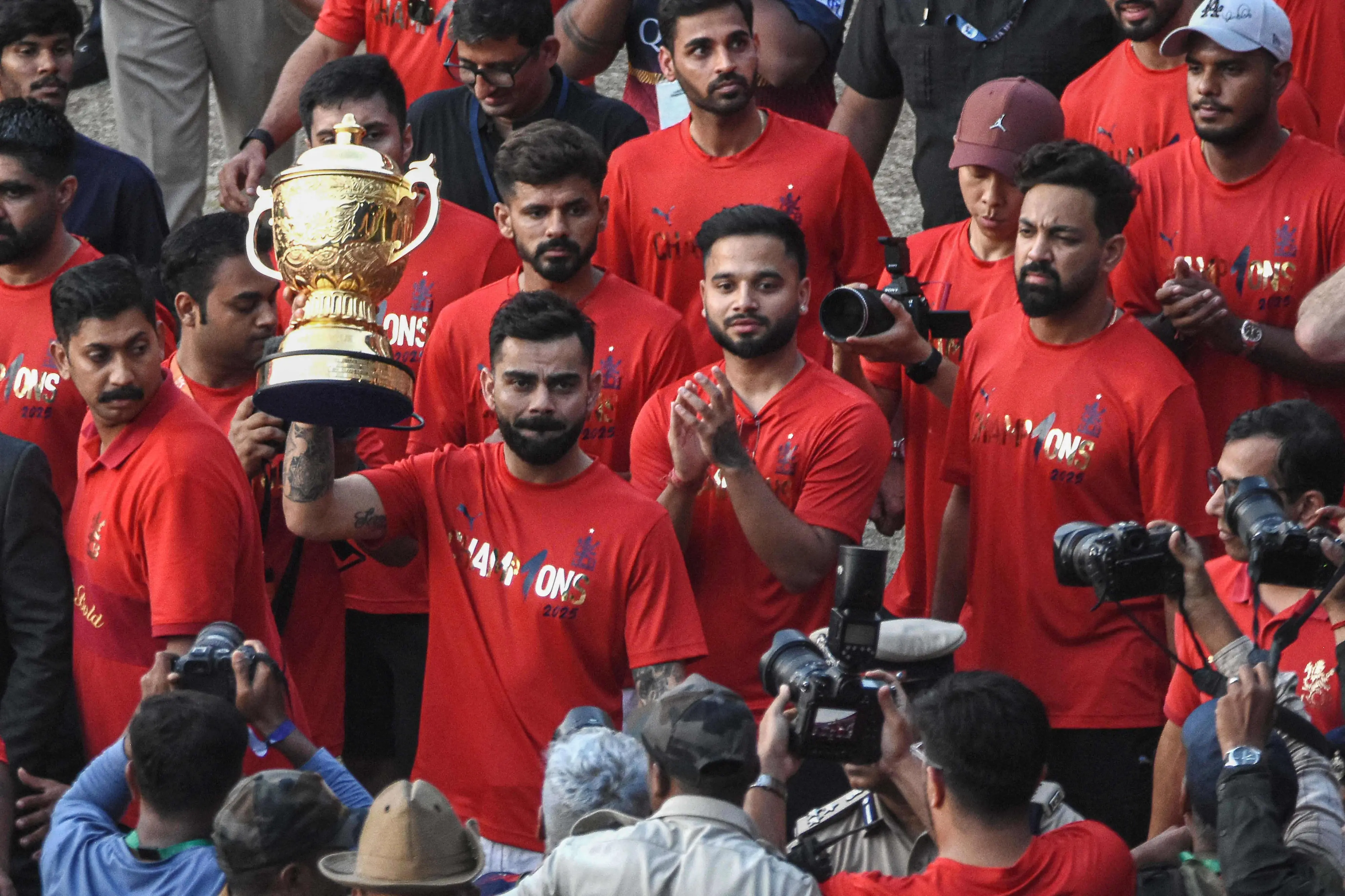 Royal Challengers Bengaluru captain Virat Kohli (2L) lifts the IPL trophy with teammates outside M. Chinnaswamy Stadium in Bengaluru on June 4, 2025. | File iamge: AFP