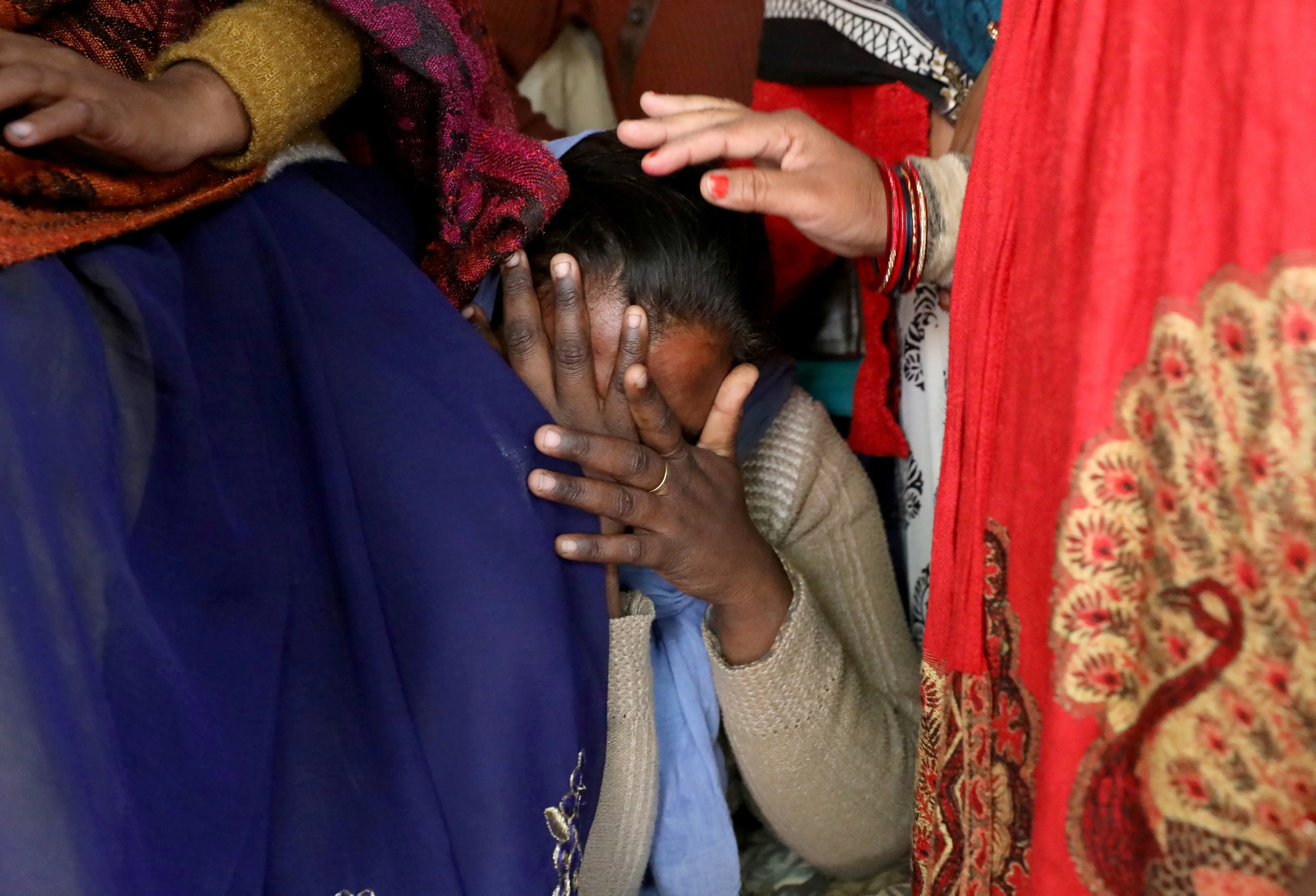 A relative of a 23-year-old rape victim, who died in a New Delhi hospital after she was set on fire by a gang of men, which included her alleged rapists, is consoled as she mourns the death of the victim outside a house in Unnao.| File image: REUTERS