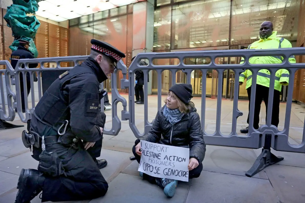 Climate activist Greta Thunberg, center, sits in front of offices of Aspen Insurance in London, England, during a protest to support the Palestine Action protesters on hunger strike in prison (Photo: AP)