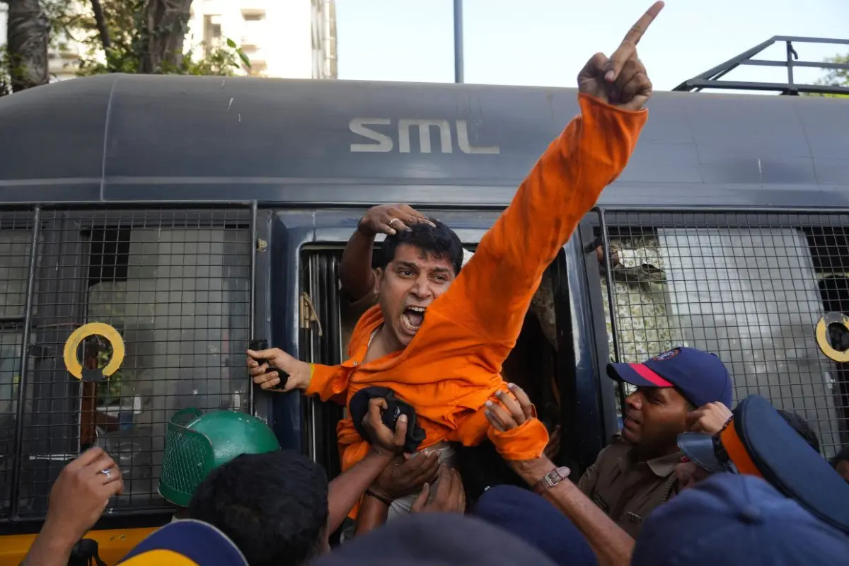 An activist from the Vishwa Hindu Parishad, a prominent right-wing Hindu nationalist organization, gestures while being detained by police during a protest near the Deputy High Commission of Bangladesh (Photo: AP)