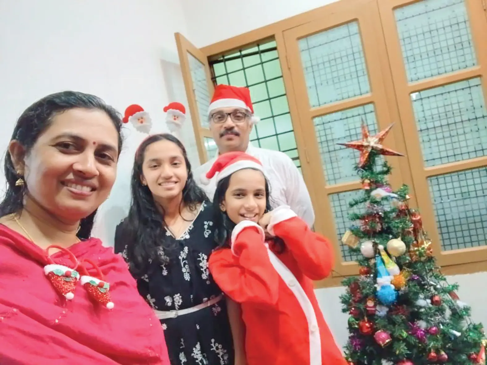 Casteless Junior, his wife Rajalakshmi, and their children Alfa Junior Casteless and Agna Junior Casteless during Christmas celebrations.