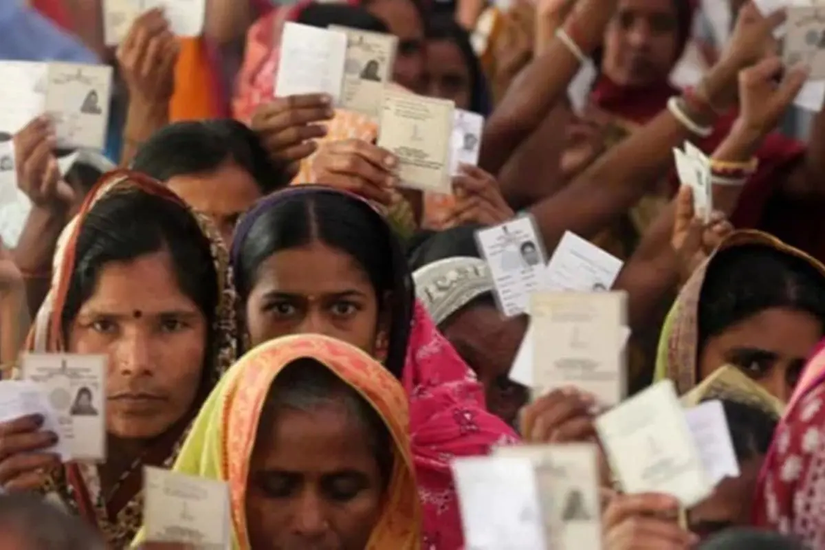 Voters display their Election Photo Identity Cards (EPIC) at a polling booth ahead of the Pune municipal elections. Photo: IANS