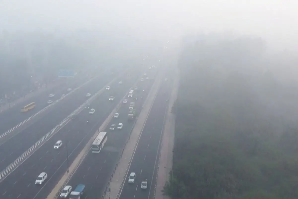 Commuters move through a thick layer of smog in the Vinod Nagar area as the Air Quality Index (AQI) remains in the 'very poor' category, in New Delhi. (ANI Video Grab)