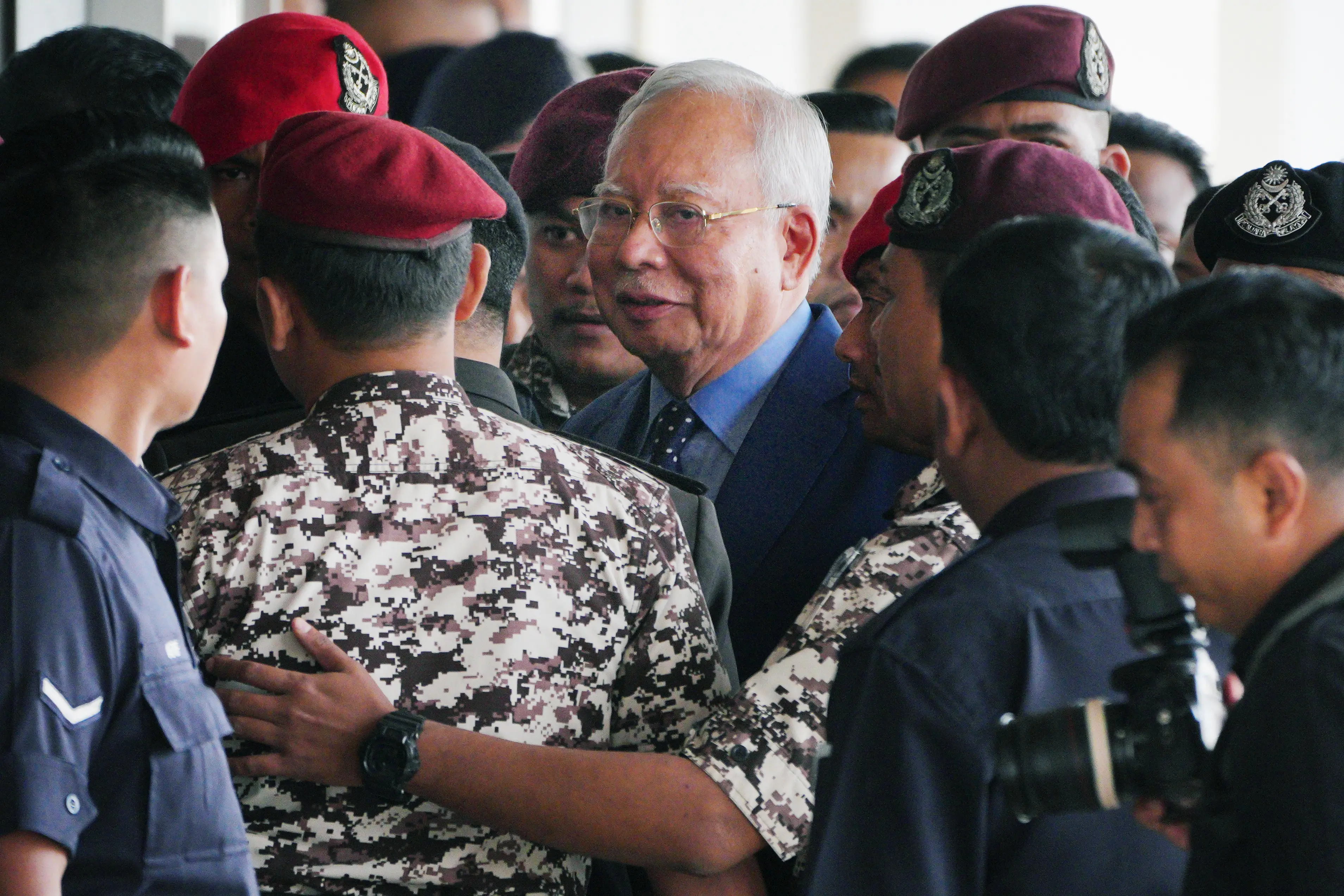 Malaysian former Prime Minister Najib Razak, center, is escorted by prison officers on his arrival at the Kuala Lumpur High Court complex in Kuala Lumpur, Malaysia.| File image: AP
