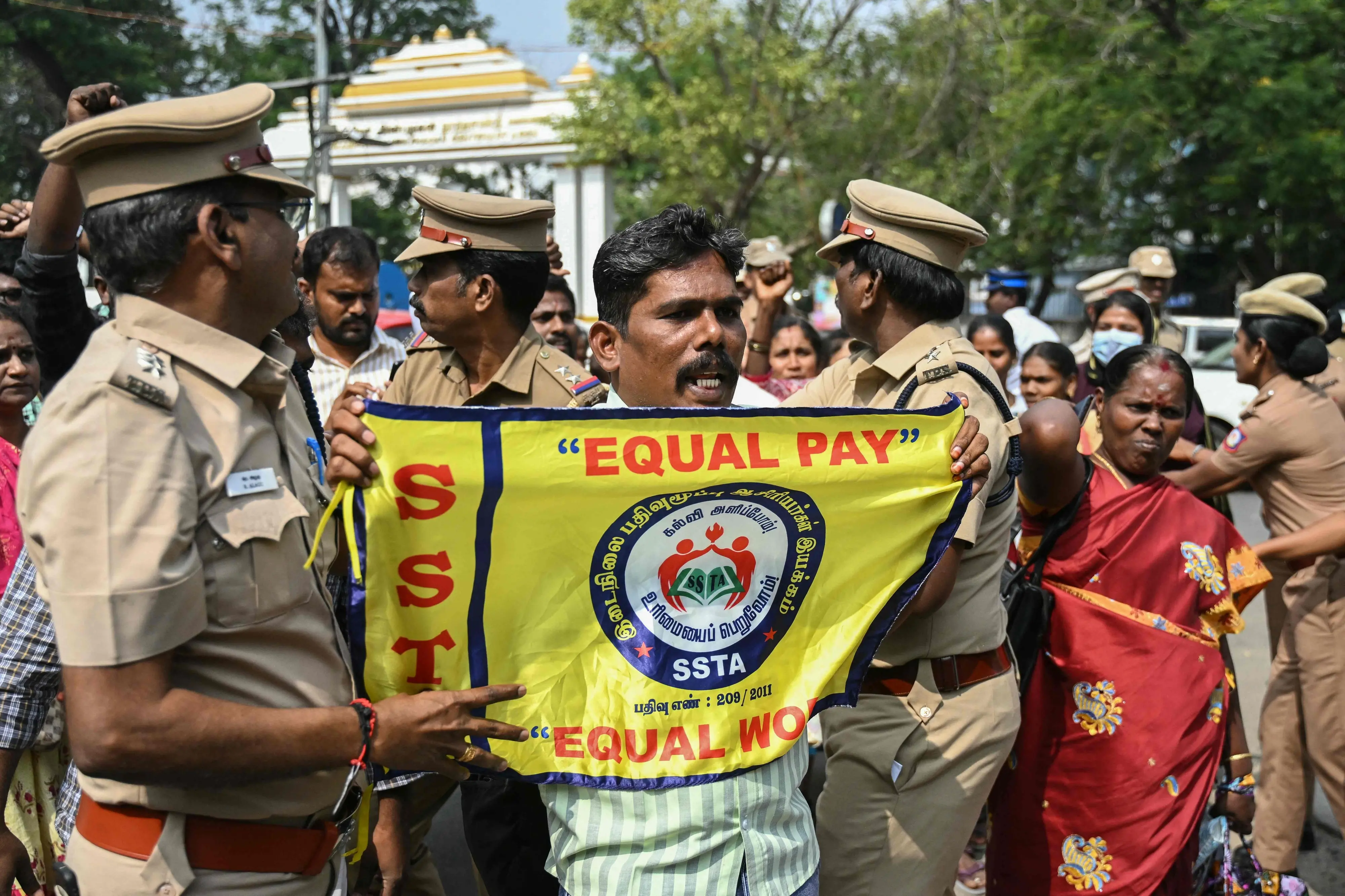 Police personnel detain a teacher during a protest demanding salary hikes and regularization of government jobs in Chennai.| Photo: PTI