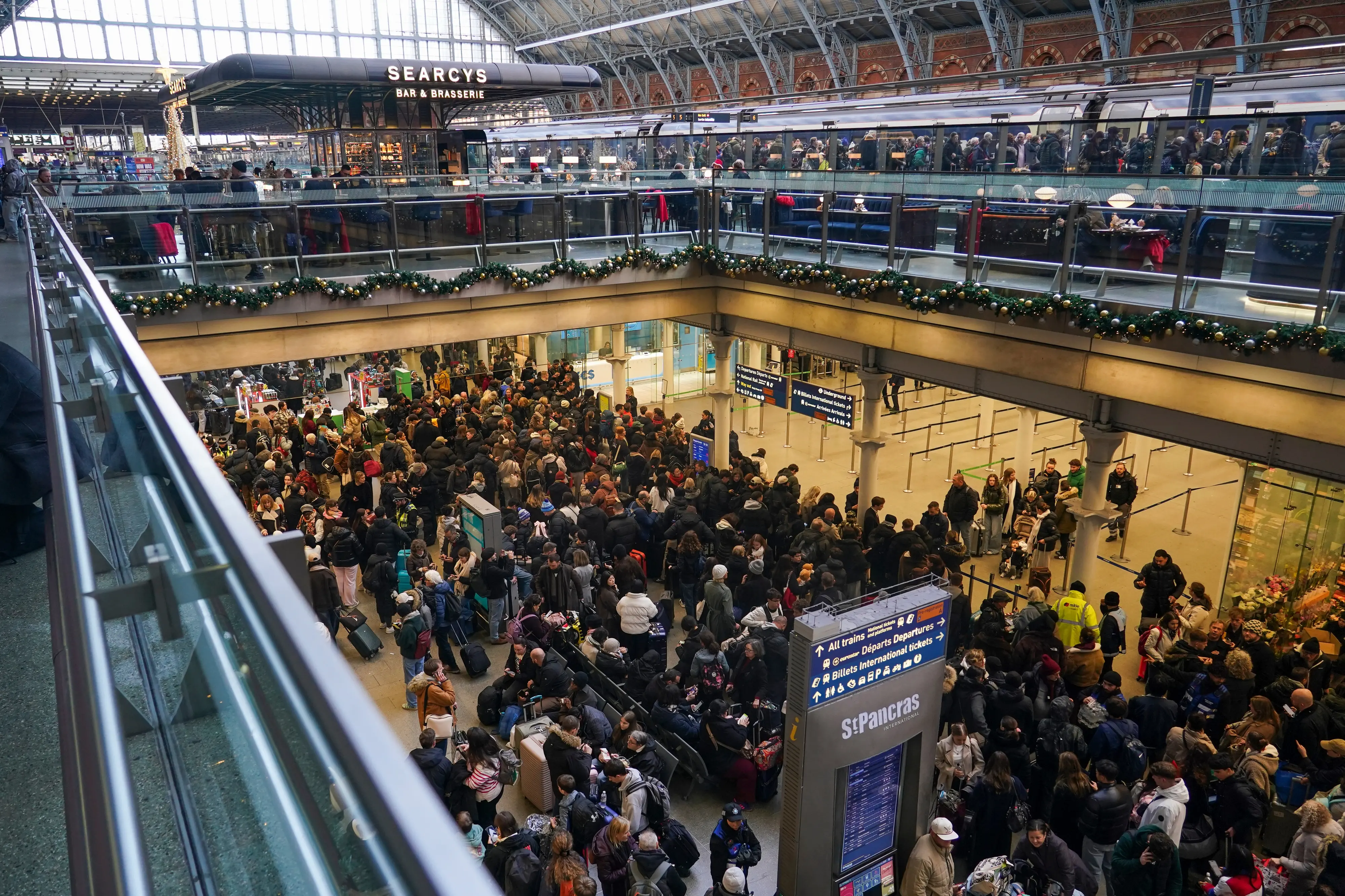 Travellers queue for Eurostar services at St Pancras International station in London | AP