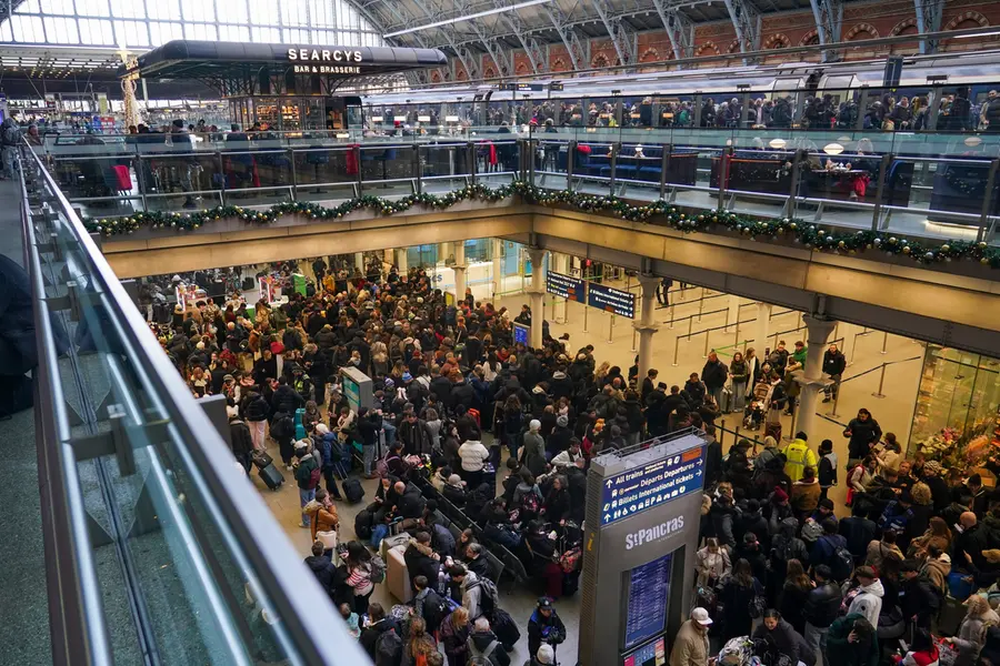Travellers queue for Eurostar services at St Pancras International station in London | AP