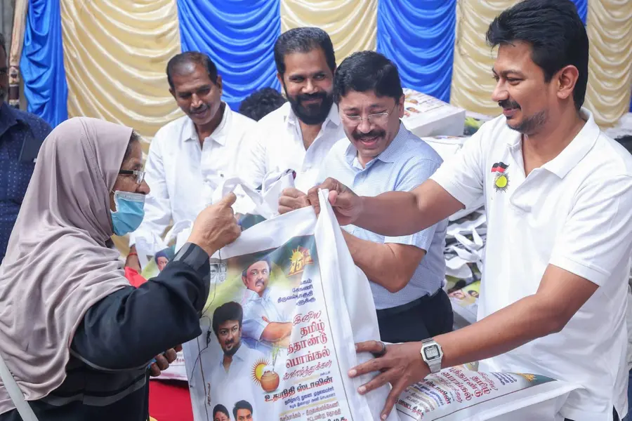 Tamil Nadu Minister Udaynidhi Stalin gives a gift set to a woman on the occasion of the Thai Pongal festival