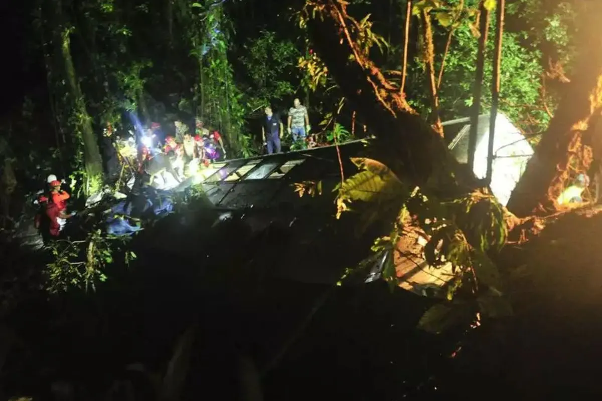 Rescue personnel work at the accident site after a bus collided head-on with a sand-laden truck on a federal highway in Rio Grande do Sul, southern Brazil, killing at least 11 people and injuring several others.