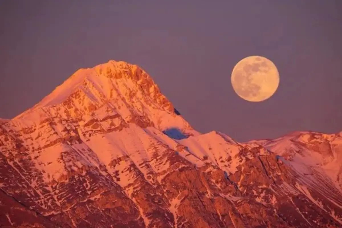 The Wolf Supermoon rises over the horizon, appearing larger and brighter than usual as it reaches its closest point to Earth, marking the first supermoon of 2026.