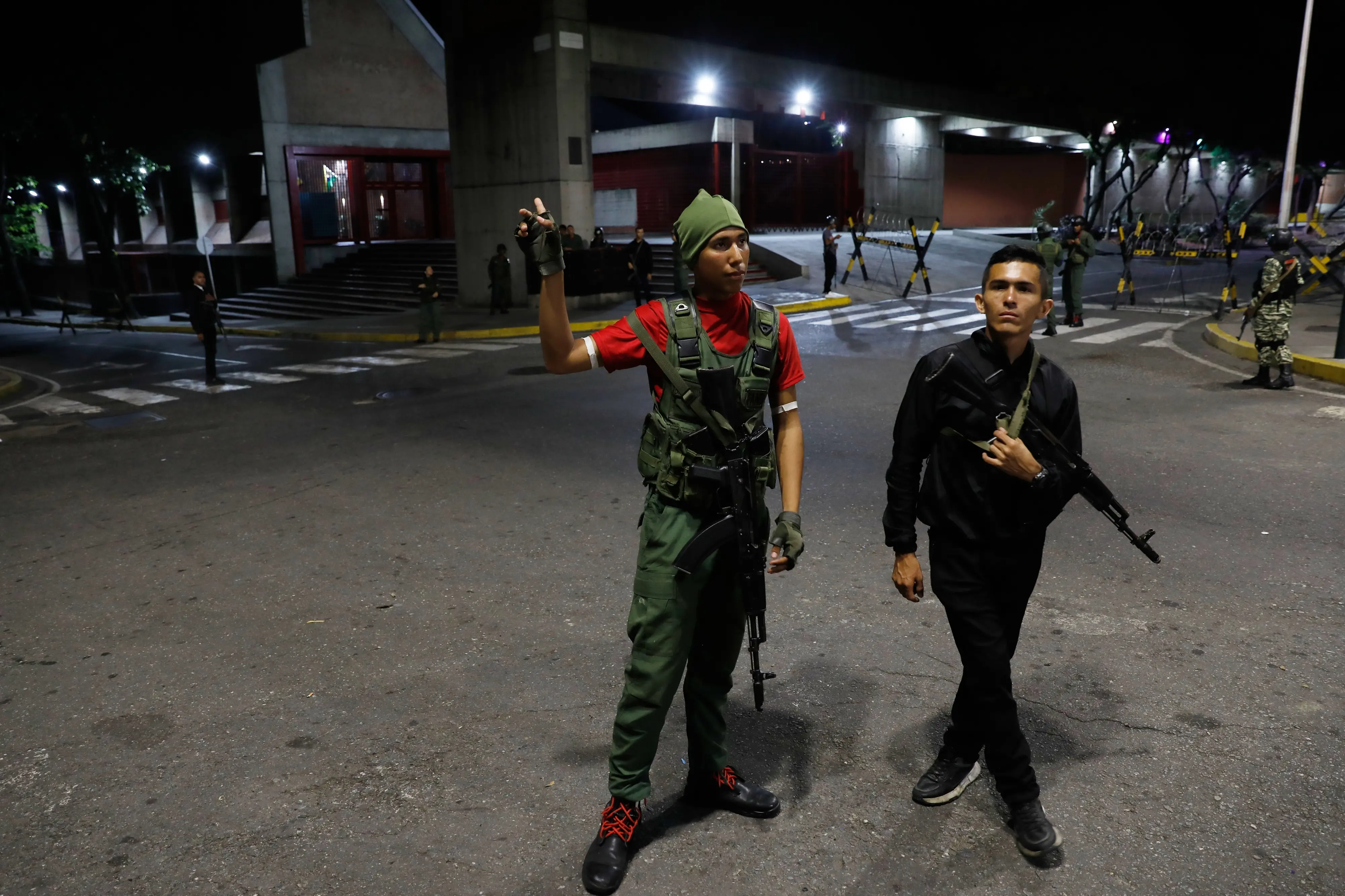 Members of the presidential guard stand outside the Miraflores presidential palace after explosions and low-flying aircraft were heard in Caracas, Venezuela | AP