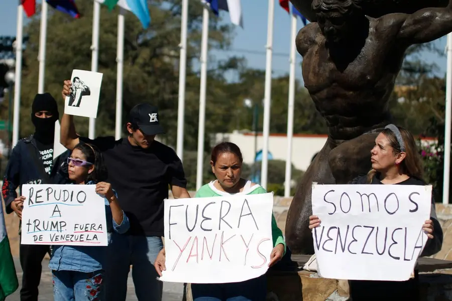 Supporters of the Venezuelan government hold signs as they protest against the US in Monterrey,