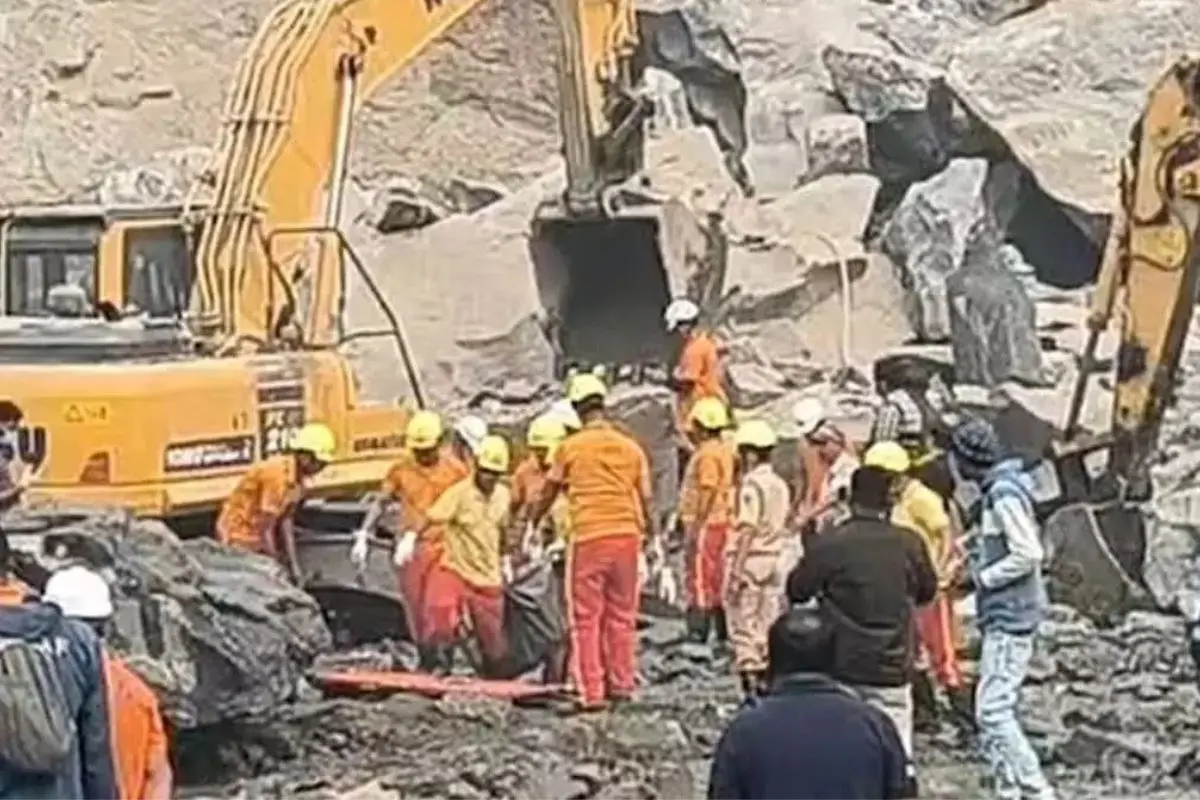 Rescue personnel and local workers search through massive rock debris at a stone quarry near Gopalpur village in Odisha's Dhenkanal district on Sunday, after a rock collapse triggered by an explosion left several people feared trapped and dead.