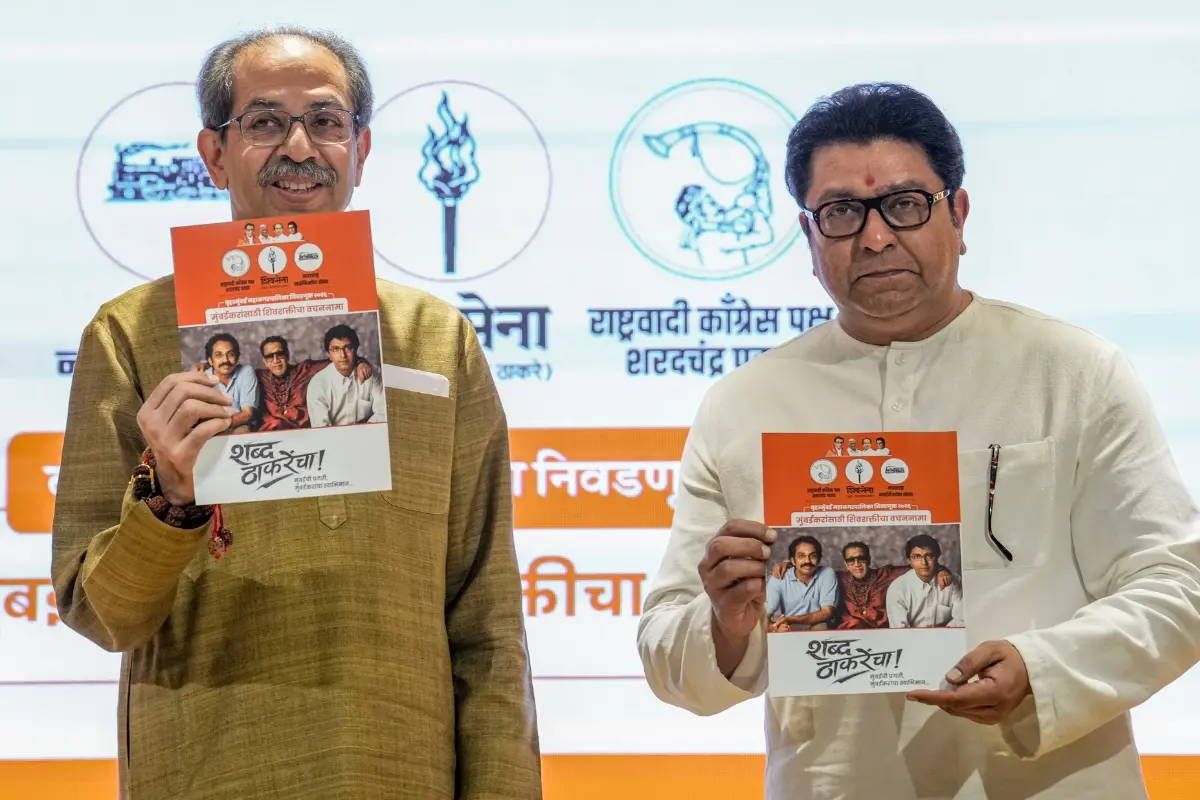 Shiv Sena (UBT) chief Uddhav Thackeray, left, and Maharashtra Navnirman Sena (MNS) chief Raj Thackeray release their alliance manifesto for the upcoming civic polls, at Sena Bhavan, in Mumbai | Photo: PTI
