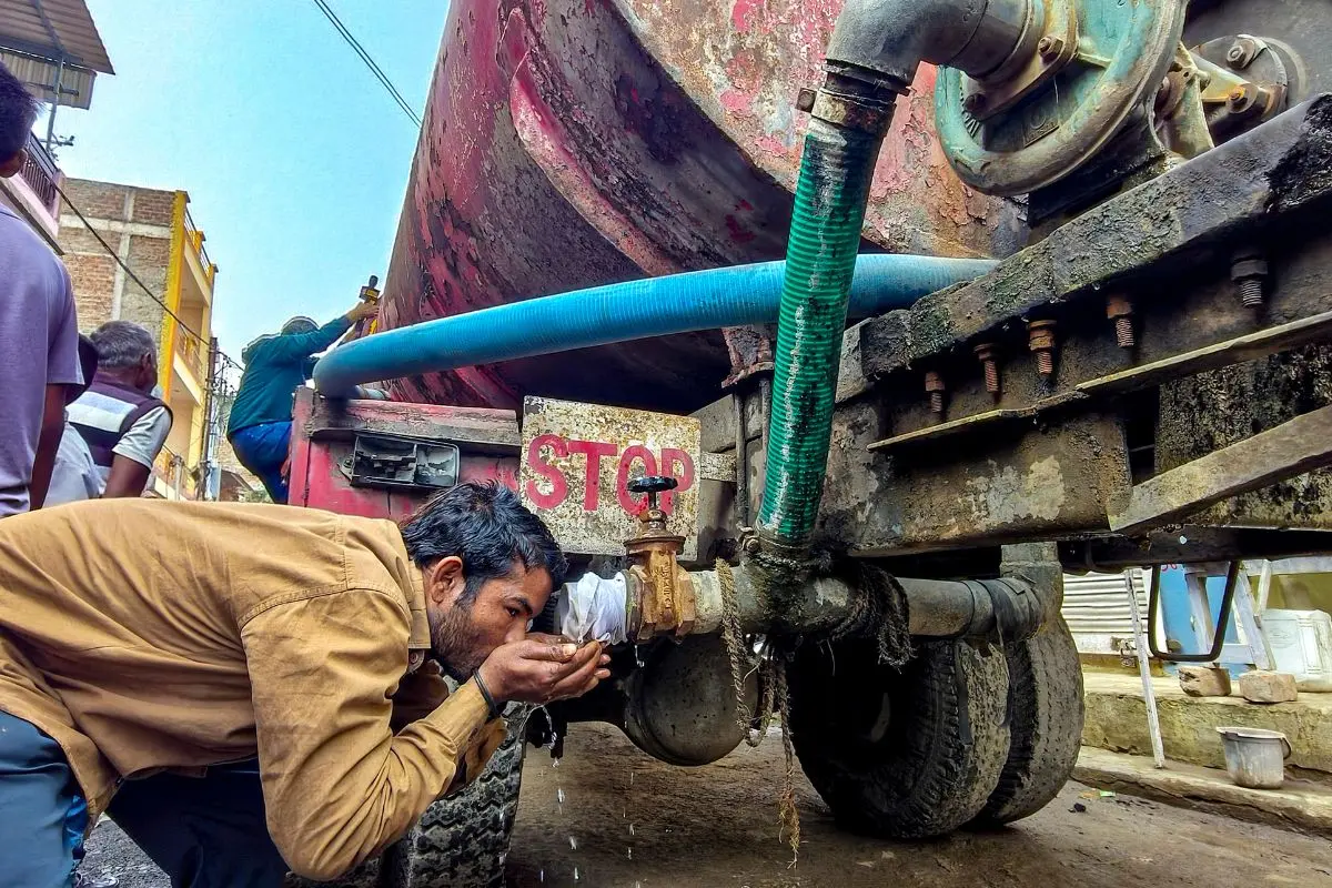 A man drinks water from a tanker amid a contaminated water crisis at Bhagirathpura, in Indore. (PTI Photo)