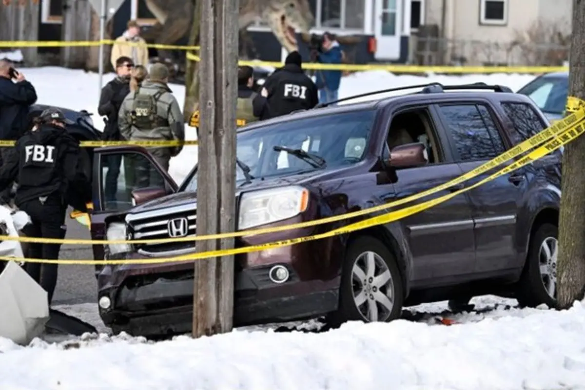 Federal agents secure the scene after an immigration officer shot and killed a woman inside an SUV during an enforcement operation in a snowy Minneapolis neighborhood, triggering protests and political backlash.