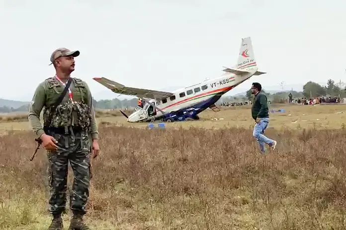 A security person stands guard at the site of IndiaOne Air nine-seater aircraft accident