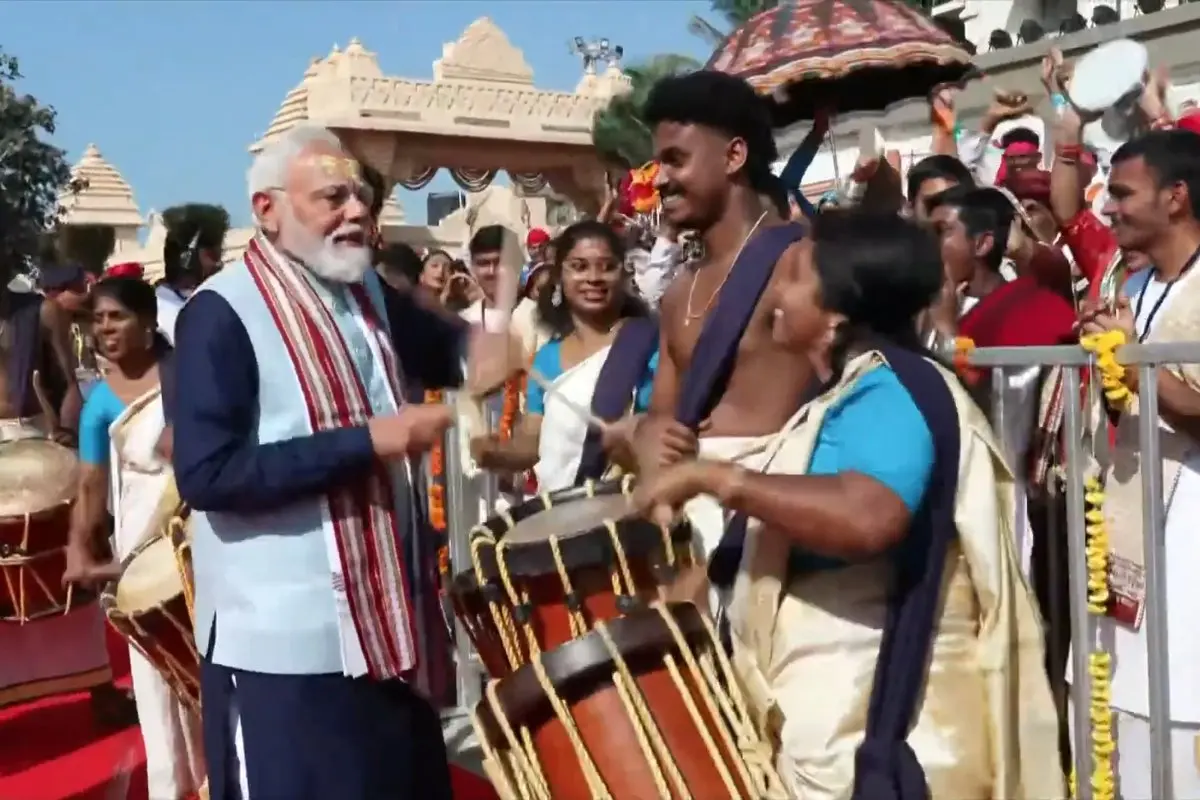 PM Modi tries the chenda and interacts with artists in attendance at the event | Photo: Screen grab YouTube/Narendra Modi