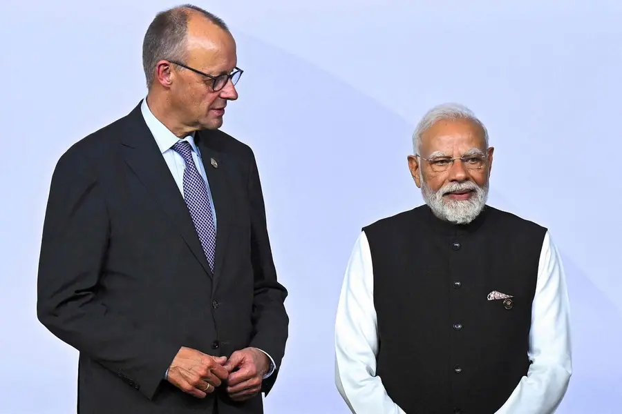 German Chancellor Friedrich Merz (L) and India's Prime Minister Narendra Modi